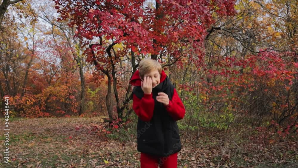 boy dancing in autumn in the forest against the background of red trees. High quality FullHD footage boy dancing in autumn in the forest against the background of red trees. High quality FullHD footage
