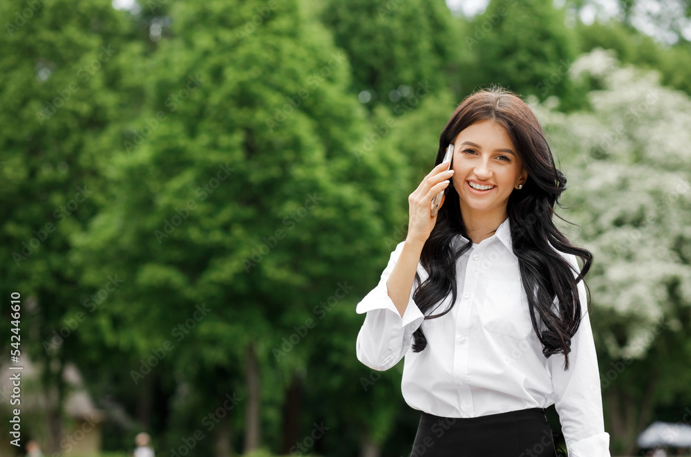 Businesswoman in formalwear talking to business partner holding paper documents.