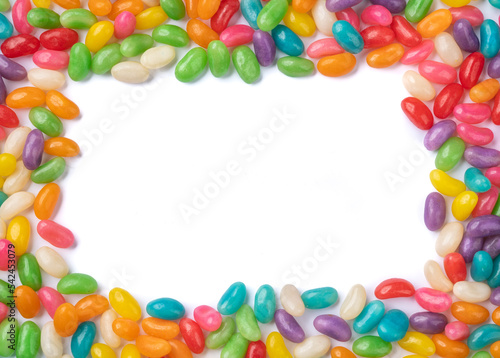 Frame of colorful jelly beans over white background with copy space