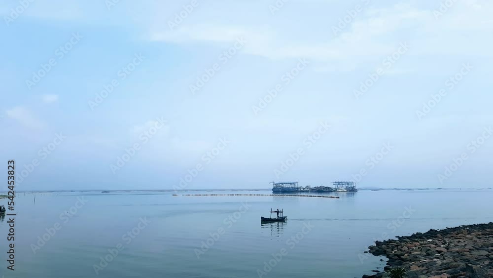 A traditional small fishing boat sailing on the sea A traditional small fishing boat sailing on the sea