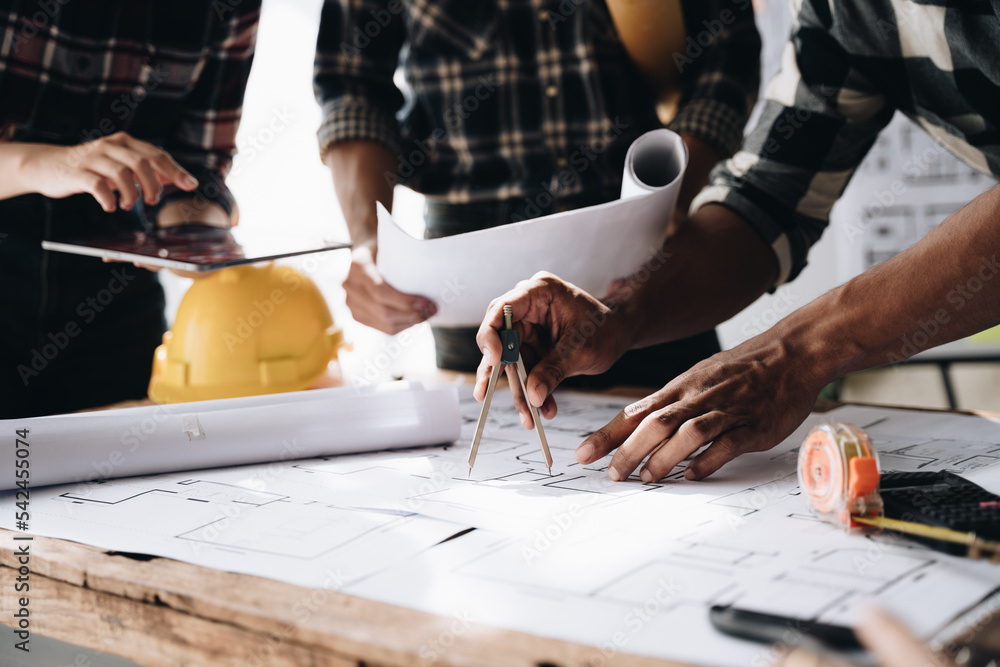 Confident team of engineers working together in a architect studio. Confident team of engineers working together in a architect studio.