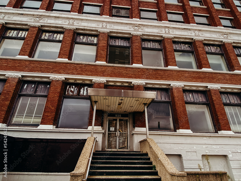 Brick building with windows and white staircase Brick building with windows and white staircase