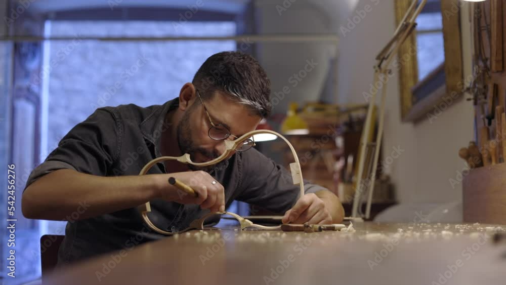 Luthier creating violin ribs in workshop Luthier creating violin ribs in workshop
