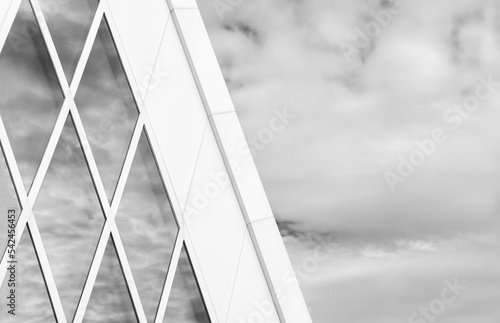 Reflection of cloud and sky on glass window of modern architecture. Building abstract background