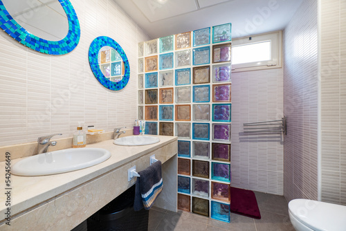 Quadro em tela Toilet with marble countertop and shower with colored glass pave screen