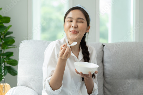 happy young woman feeling joy with delicious food her face have a big smile on the sofa at home
