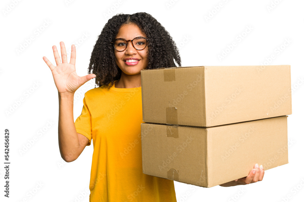 Young african american woman moving to other house while picking up a box full of things isolated smiling cheerful showing number five with fingers. Young african american woman moving to other house while picking up a box full of things isolated smiling cheerful showing number five with fingers.