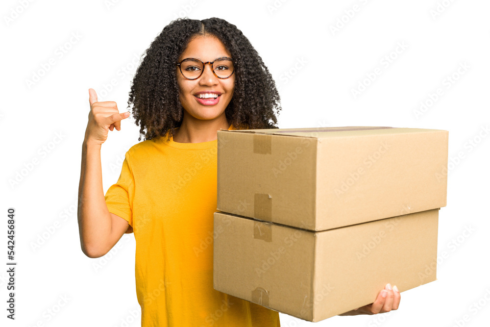 Young african american woman moving to other house while picking up a box full of things isolated showing a mobile phone call gesture with fingers. Young african american woman moving to other house while picking up a box full of things isolated showing a mobile phone call gesture with fingers.
