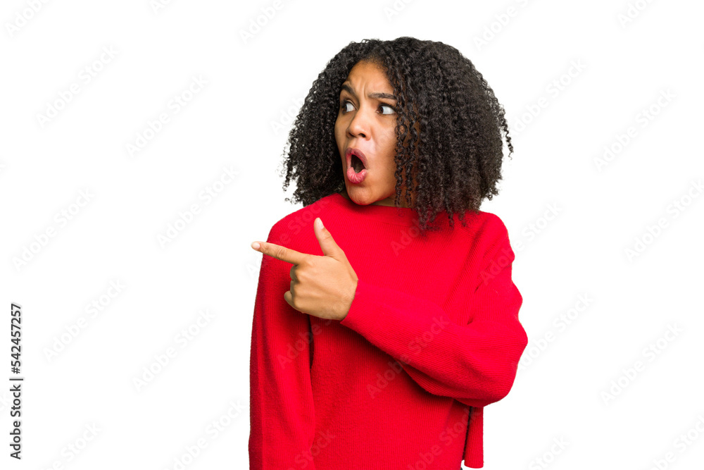 Young african american woman isolated points with thumb finger away, laughing and carefree. Young african american woman isolated points with thumb finger away, laughing and carefree.
