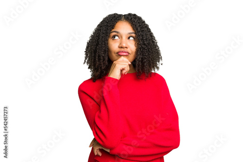 Young african american woman isolated relaxed thinking about something looking at a copy space.