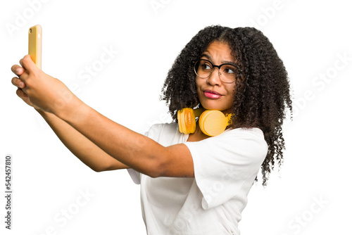 Young african american woman listening to music with headphones isolated