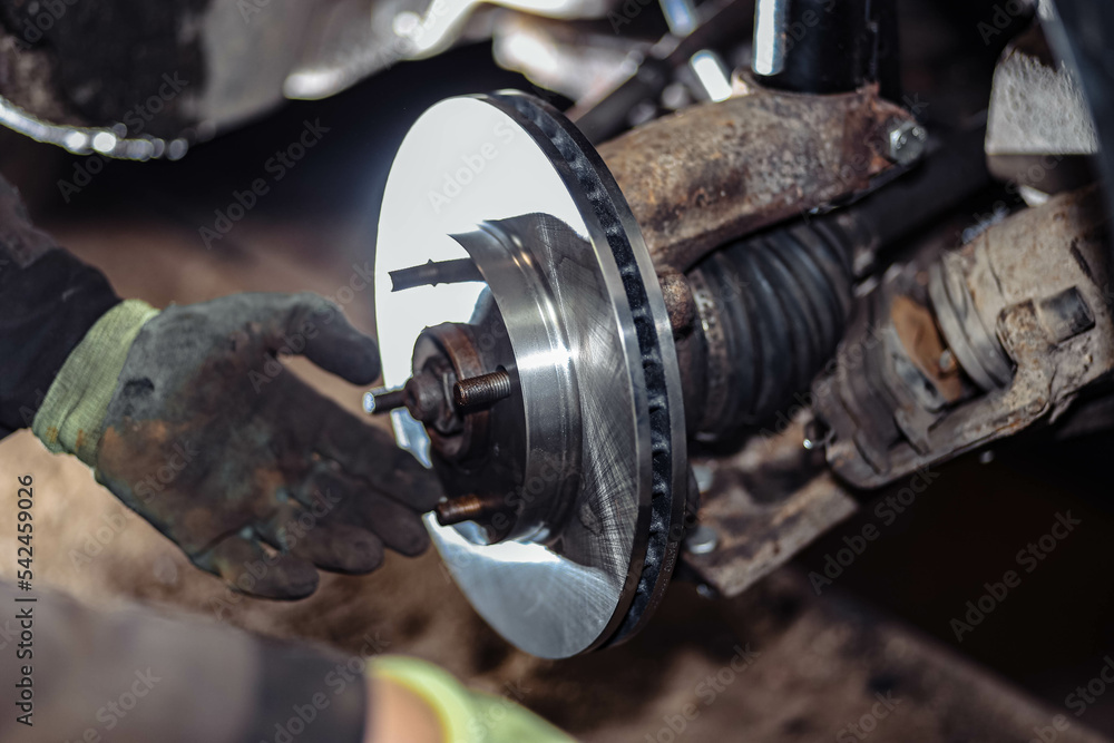 installation and replacement of car brake discs in a car service. installation and replacement of car brake discs in a car service.