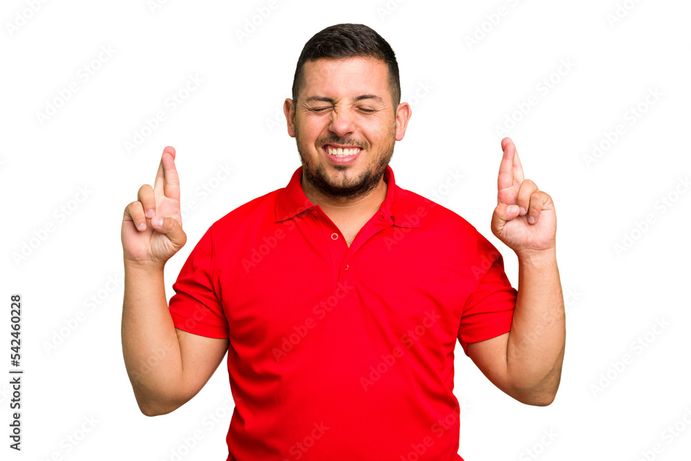 Young caucasian man isolated crossing fingers for having luck Young caucasian man isolated crossing fingers for having luck
