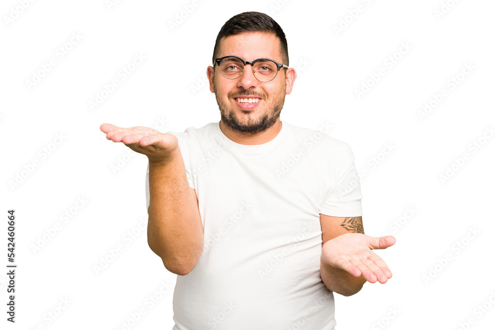 Young caucasian man isolated makes scale with arms, feels happy and confident. Young caucasian man isolated makes scale with arms, feels happy and confident.