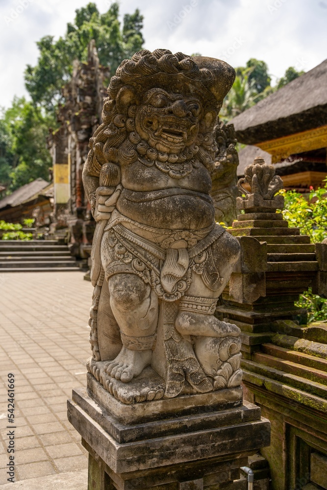 Vertical closeup of ancient statue in a temple in Bali, Indonesia
