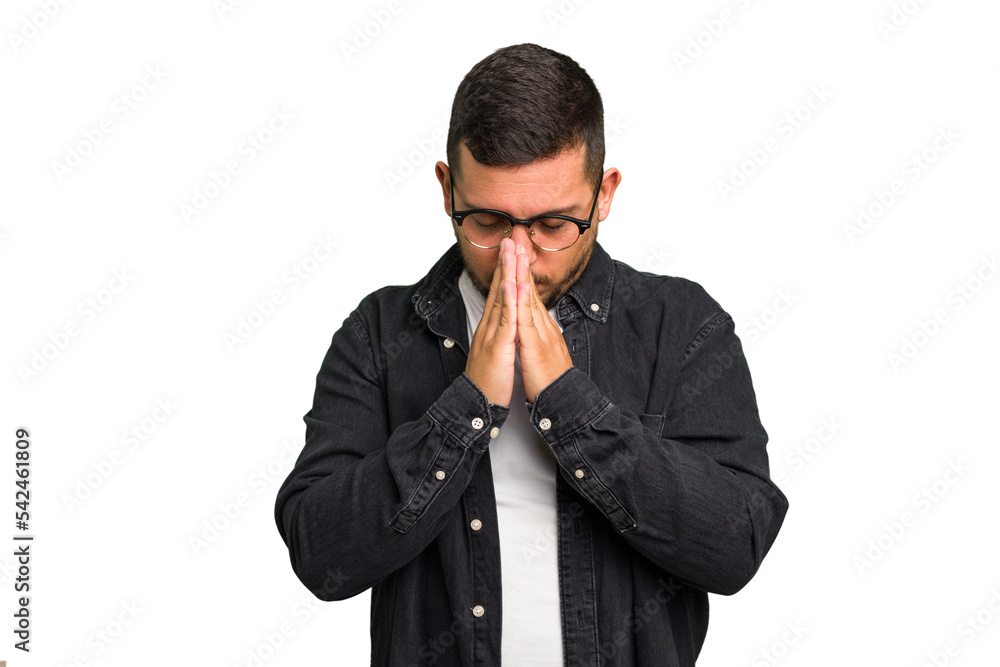 Young caucasian man isolated praying, showing devotion, religious person looking for divine inspiration. Young caucasian man isolated praying, showing devotion, religious person looking for divine inspiration.