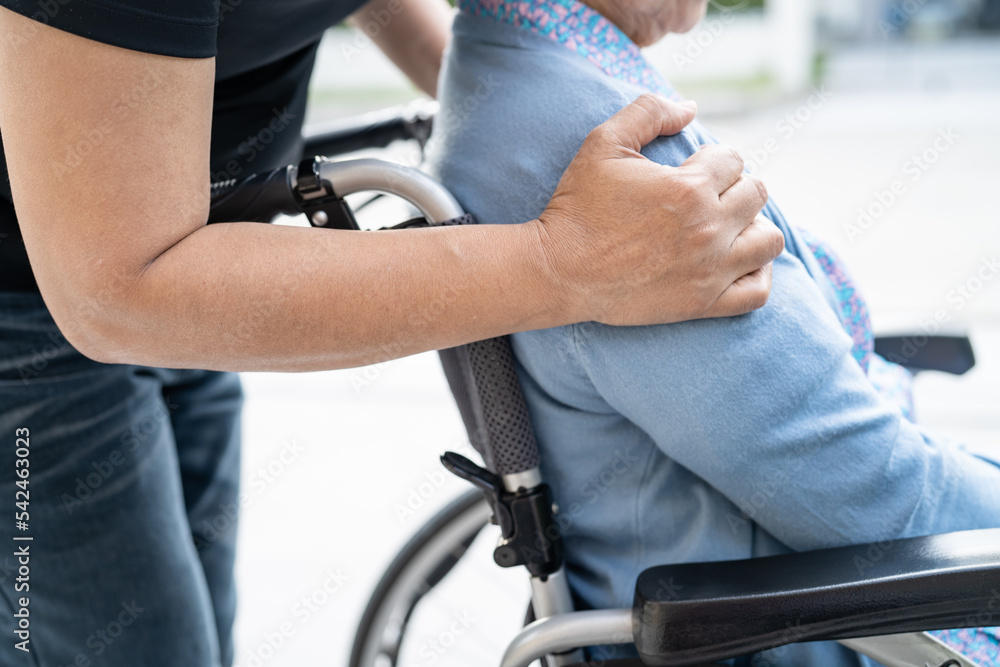 Obraz premium Caregiver help and care Asian senior or elderly old lady woman patient sitting on wheelchair at nursing hospital ward, healthy strong medical concept