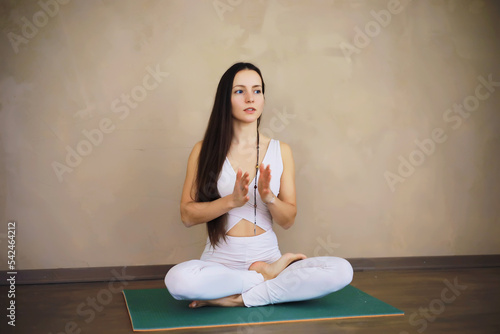 Beautiful athletic girl doing yoga exercises enjoy meditation at home. No stress, healthy habit, anxiety relief concept. Lotus pose.