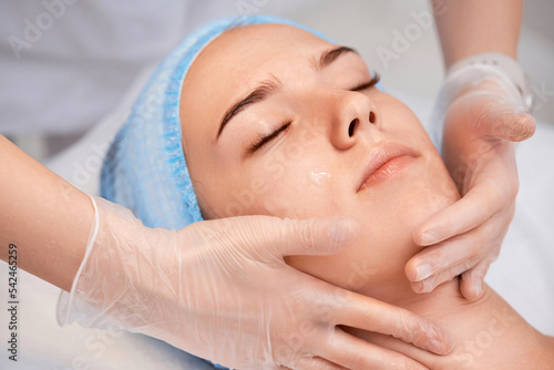 woman receiving facial massage at spa salon