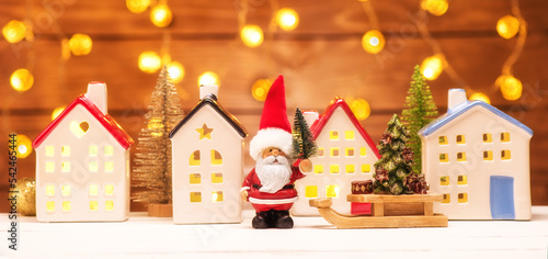 Christmas banner Santa Claus and fairy houses with garland lights