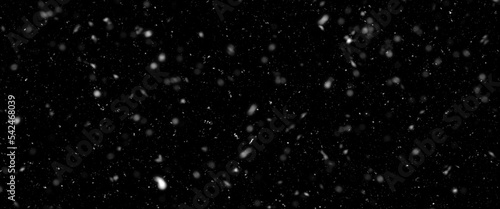 Falling snow isolated on black background. Falling snow at night. Bokeh lights on black background  flying snowflakes in the air. Winter weather. Overlay texture.