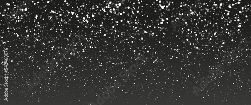 Falling snow isolated on black background. Falling snow at night. Bokeh lights on black background, flying snowflakes in the air. Winter weather. Overlay texture.