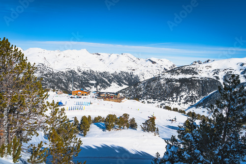 People, families, skiers and snowboarders relaxing and having fun in winter at Soldeu ski lifts cross centre, Grandvalira, Andorra, Pyrenees Mountains photo