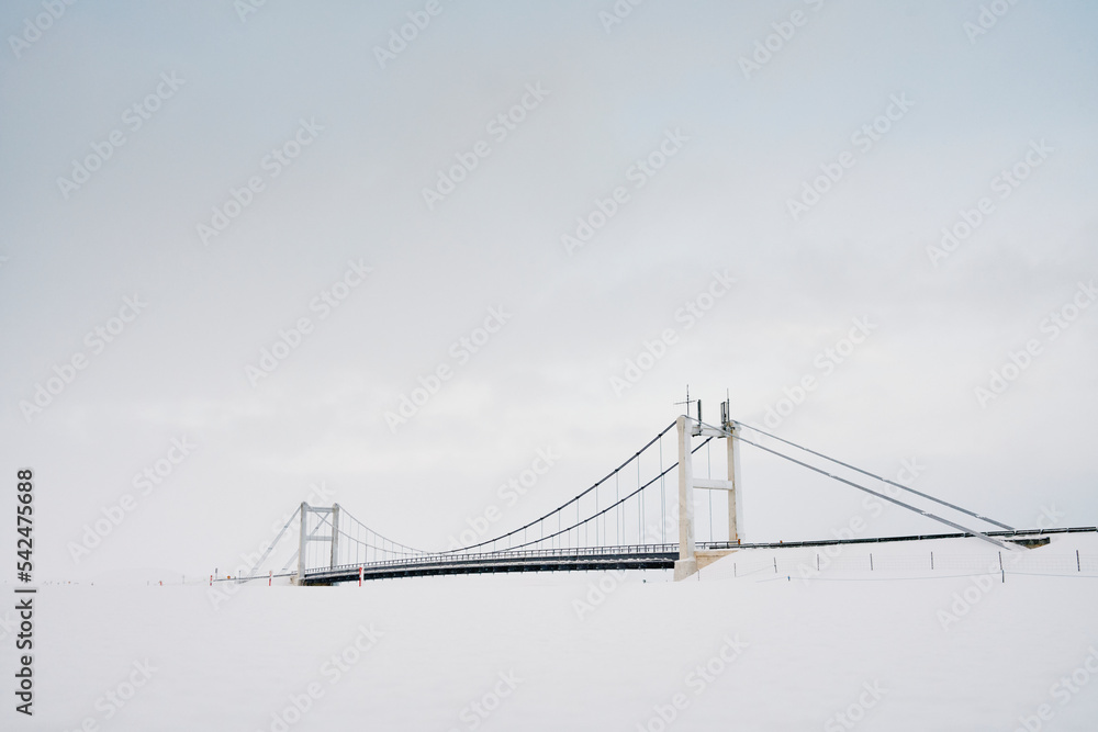 Bridge over frozen river in winter