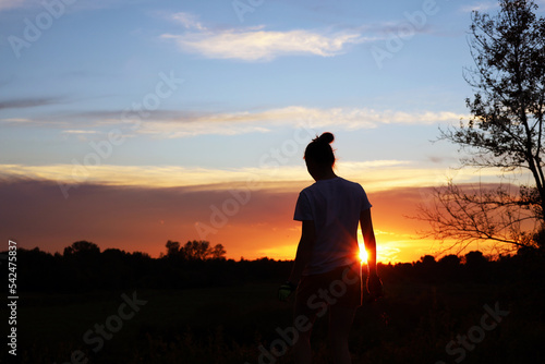 A teenage girl in the rays of the setting sun © Cavan