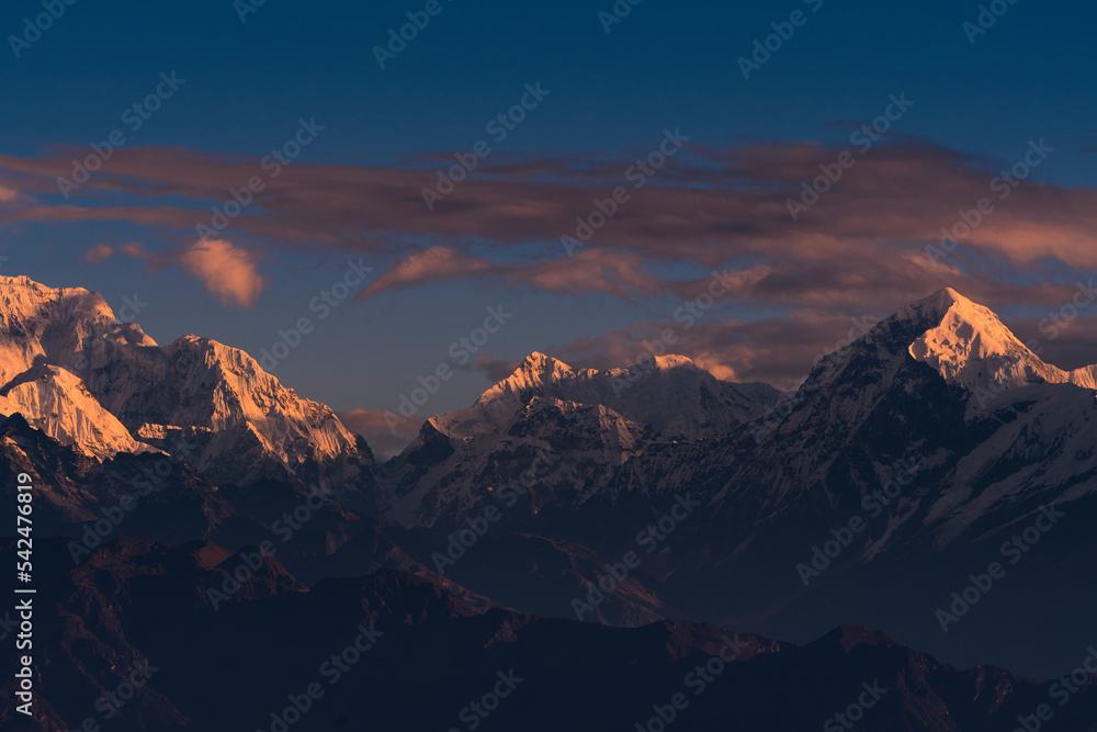 First ray of morning sun on the peaks of majestic Kangchenjunga range (third highest in the World) of Himalayas. Photo taken from Sandakphu, West Bengal.