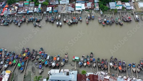 Fishing boats lined at river shore, Patuakhali, Bangladesh. photo