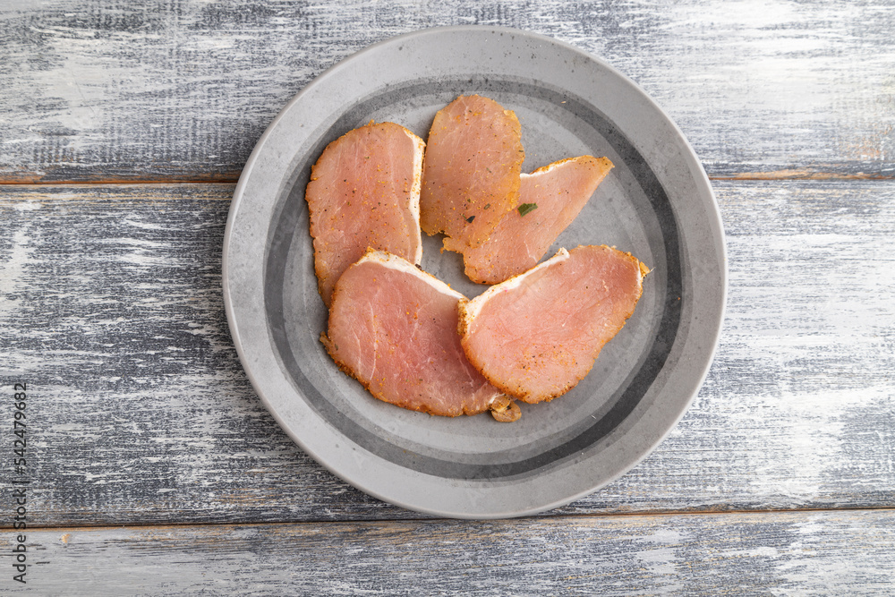 salted meat on a wooden plate on a gray. Top view. salted meat on a wooden plate on a gray. Top view.