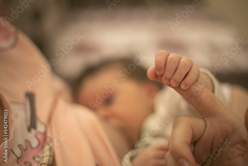 a small child drinks mother's milk
