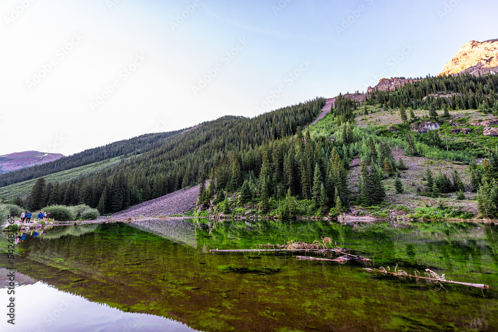 Aspen, Colorado Maroon Bells wide angle view in summer water reflection, people standing with tripods taking pictures