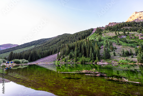 Aspen, Colorado Maroon Bells wide angle view in summer water reflection, people standing with tripods taking pictures