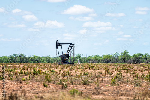 Canvas Print Sweetwater, Texas oil pumpjack on Oilfields of USA with metal machine in brown f