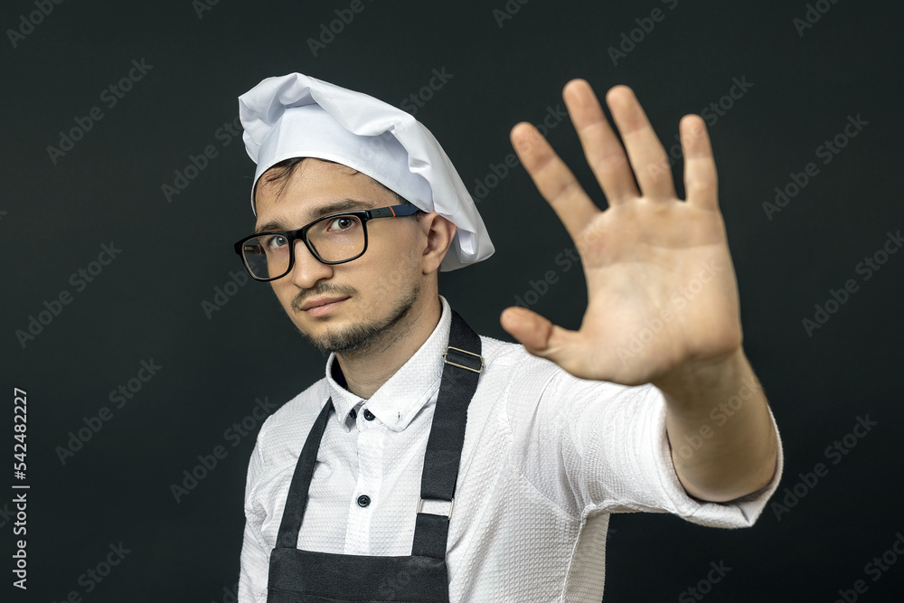 the chef put his palm forward and wants to distance himself. stop concept the chef put his palm forward and wants to distance himself. stop concept