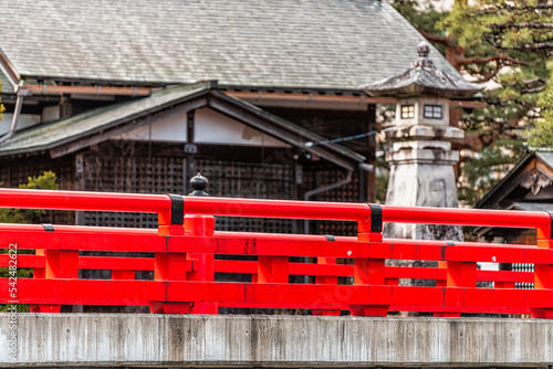 Red vermilion color bridge railing over Enako river Stone paved path footpath in Takayama, Japan at Higashiyama walking course in historic city of Gifu Prefecture by Tounin temple shrines photo