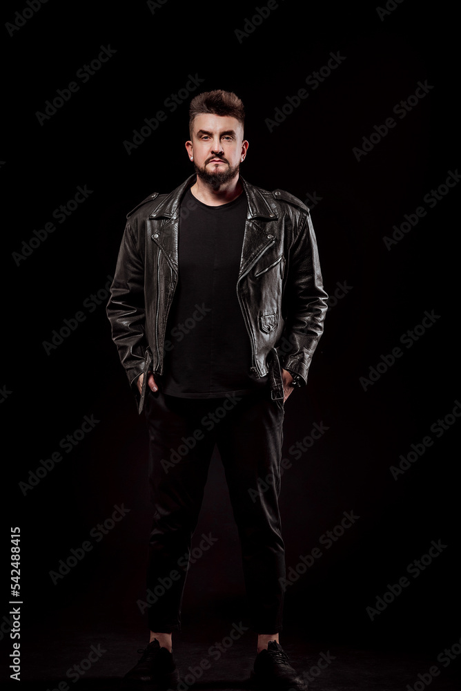portrait of a man in a leather jacket and in the studio on a black background portrait of a man in a leather jacket and in the studio on a black background