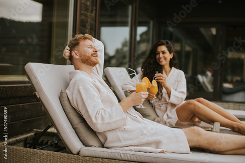 Young couple relaxing on be...