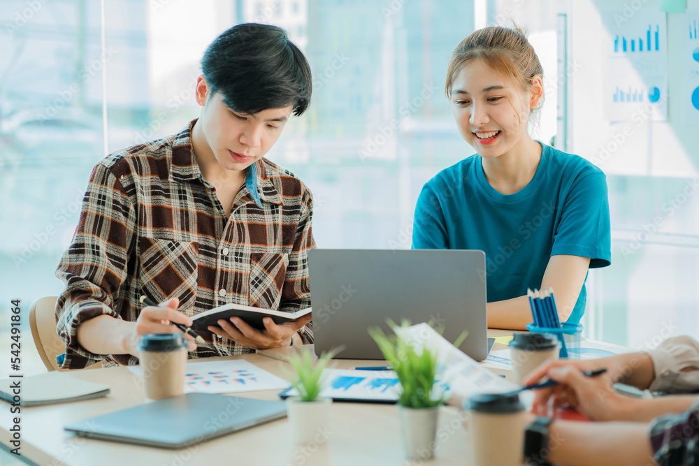 
Young happy Asian businessman working together to start a business in creative team brainstorming meeting Successful business partner team work concept