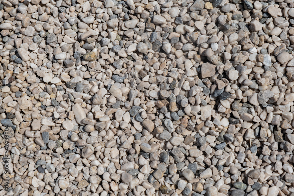 Stone gravel texture at a construction site or beach background warm colored pebbles Stone gravel texture at a construction site or beach background warm colored pebbles