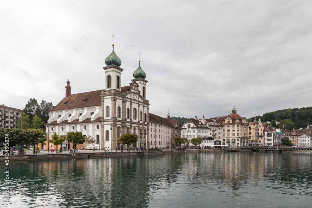 City of Luzern, Switzerland, showing the church next to the famous Chapel Bridge reflected in the water