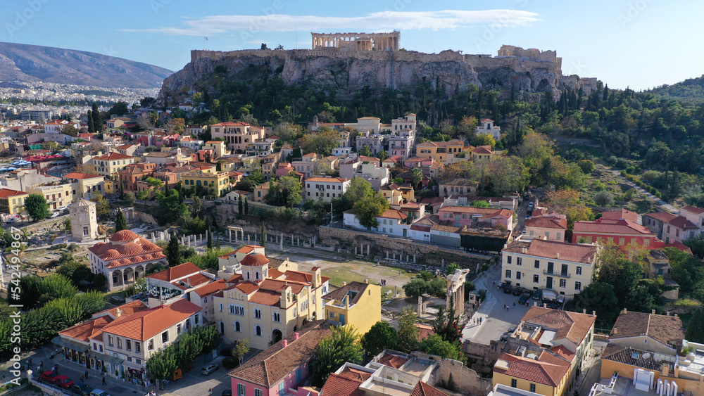 Aerial drone photo of iconic Acropolis hill and the Parthenon as seen from picturesque Plaka district - ancient Roman forum, Athens historic centre, Attica, Greece