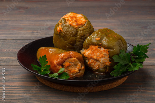 stuffed bell peppers on a plate on a wooden background