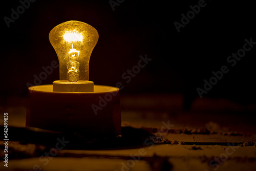 An old lamp dimly illuminates the space around it.