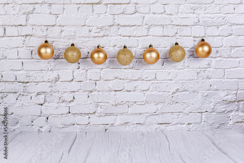 golden Christmas toys on the background of a brick wall