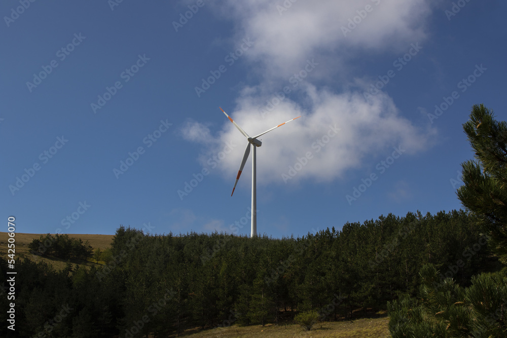 A wind farm or wind park with wind turbine located in the mountains of Italy Europe and it allows to realize clean energy. It’s sustainable, renewable energy for enviromental A wind farm or wind park with wind turbine located in the mountains of Italy Europe and it allows to realize clean energy. It’s sustainable, renewable energy for enviromental