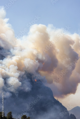 BC Forest Fire and Smoke over the mountain near Hope during a hot sunny summer day. British Columbia, Canada. Wildfire natural disaster