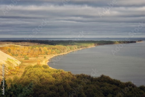 landscape with a peninsula jutting out far into the sea and a cloudy sky